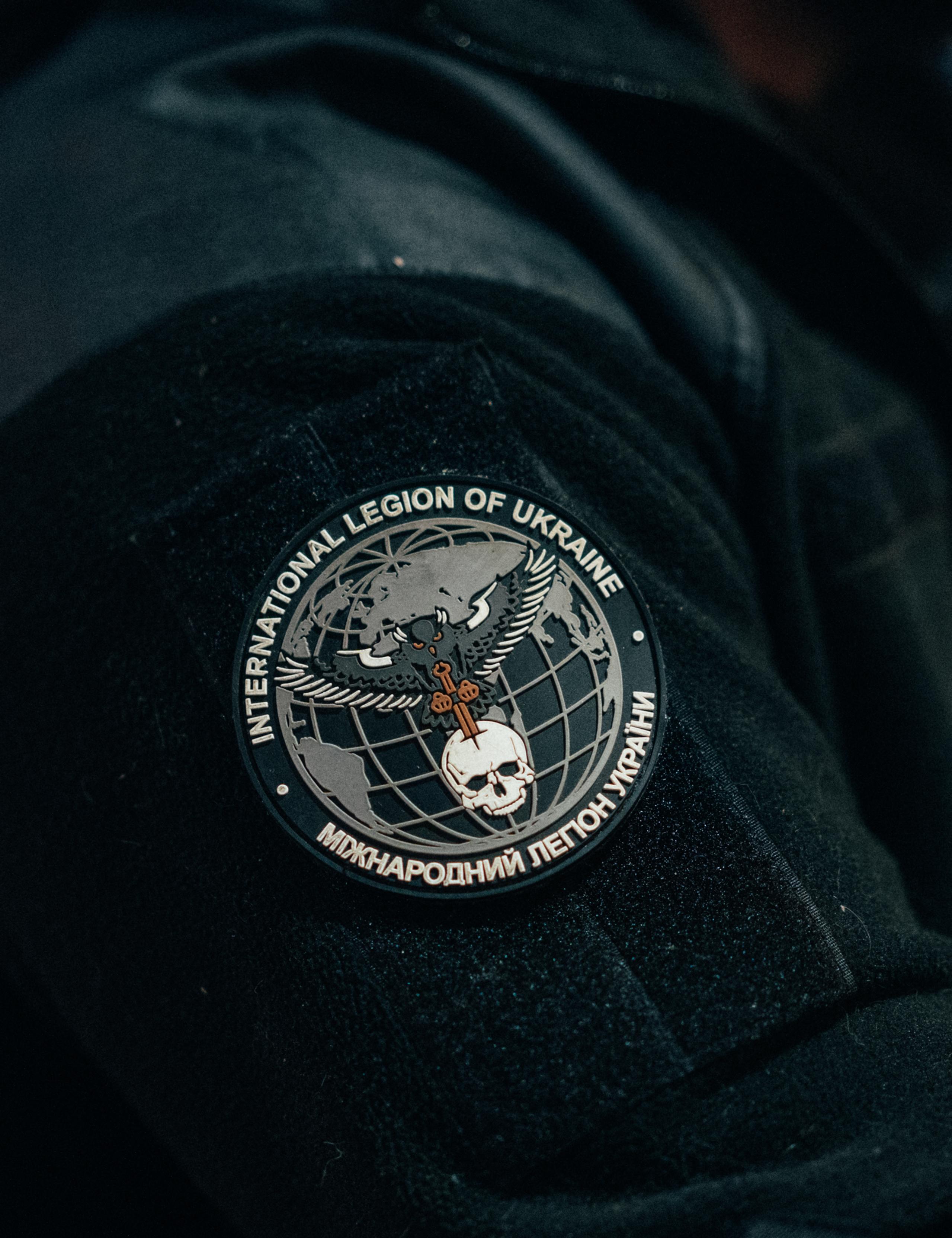 Closeup of Internation Legion of Ukraine patch with owl and skull illustration
