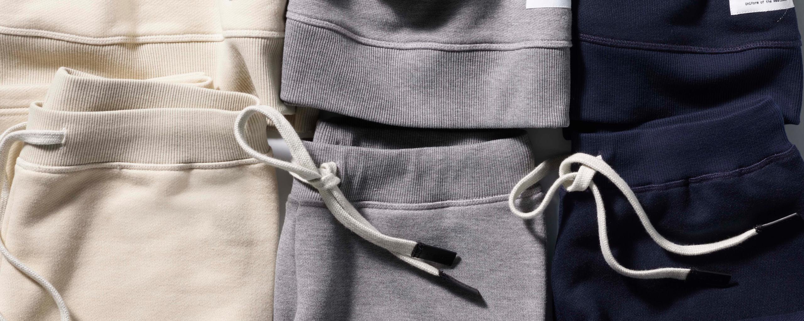 Group of Foundation sweatshirts and sweatpants laid down together in still-life photo