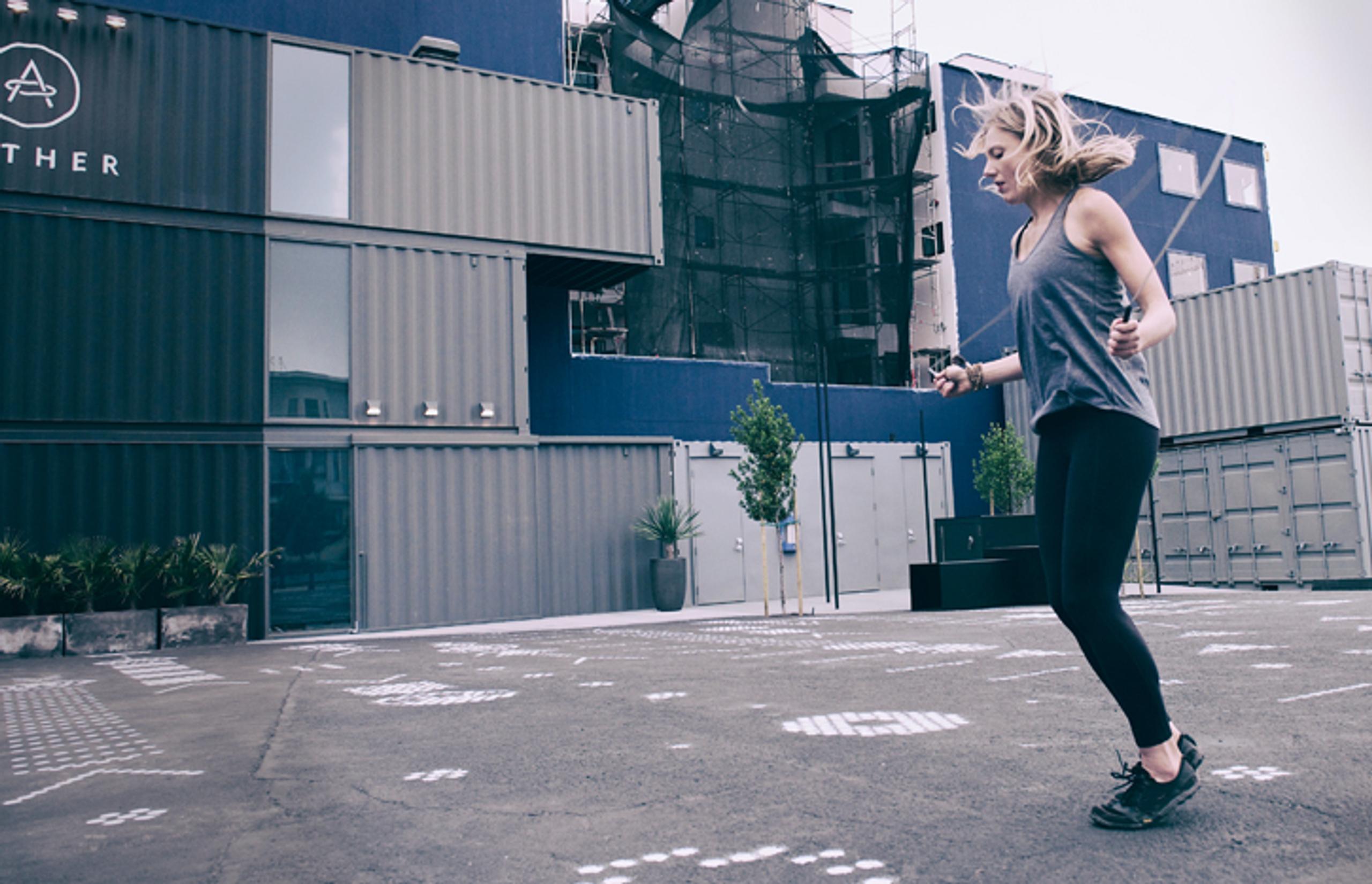 woman jumproping in front of the AETHER store in San Francisco