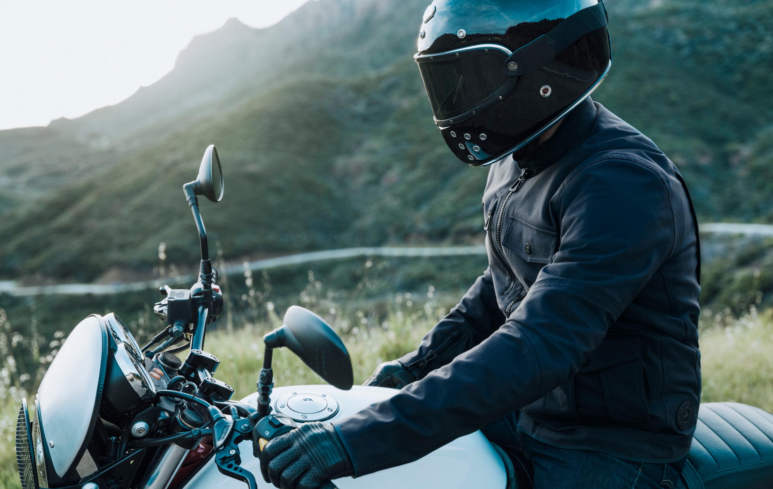 Man in Mulholland Motorcycle Jacket sitting on motorcycle roadside in Malibu hills