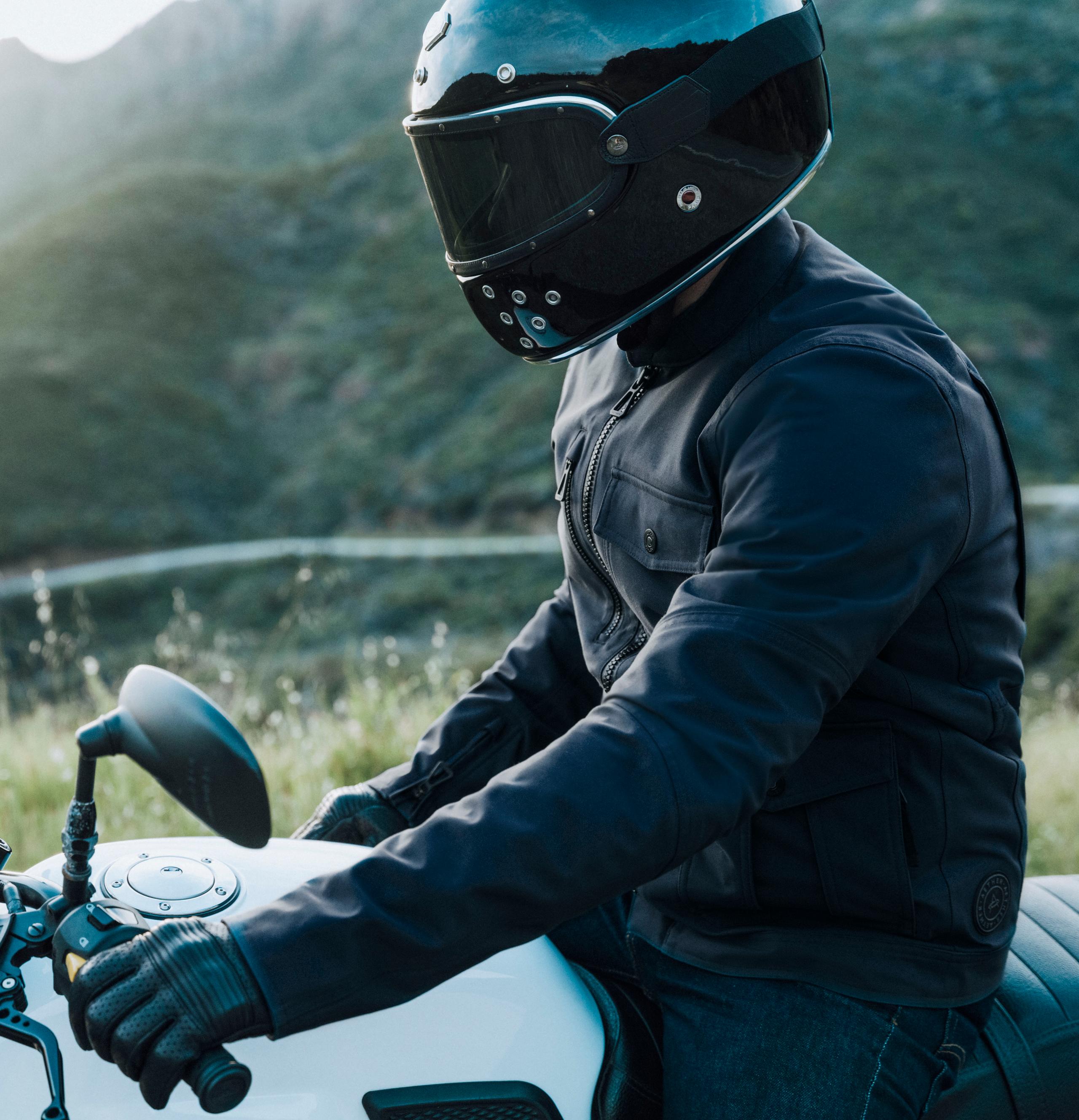 Man in Mulholland Motorcycle Jacket sitting on motorcycle roadside in Malibu hills