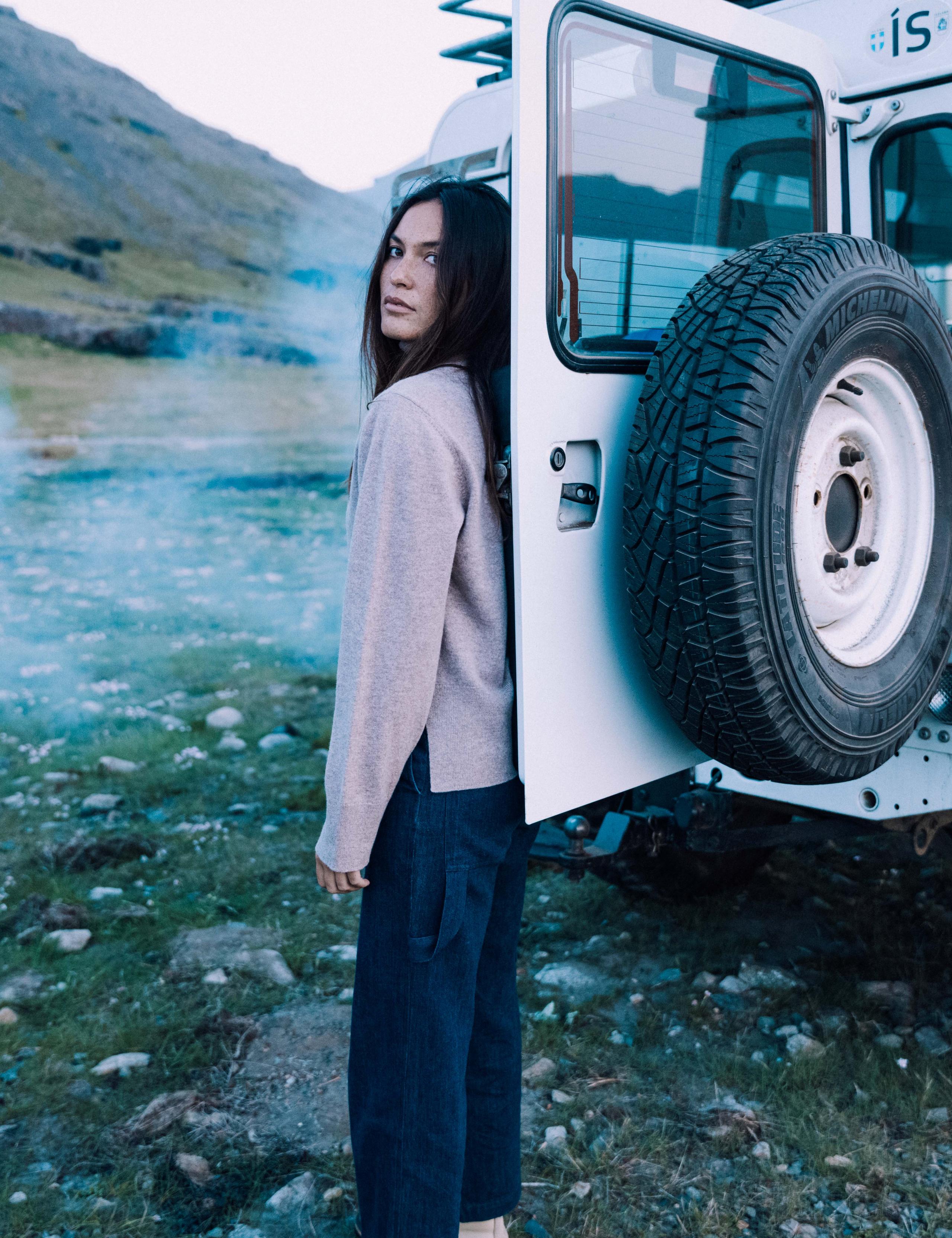Woman wearing Leigh Cashmere Turtleneck Sweater standing next to a Land Rover Defender.