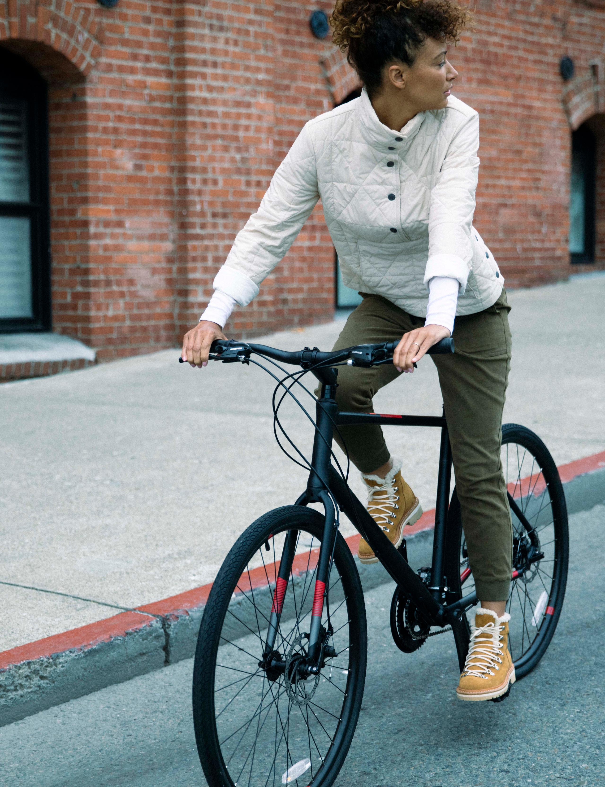 Women wearing Marsh Pullover on bicycle