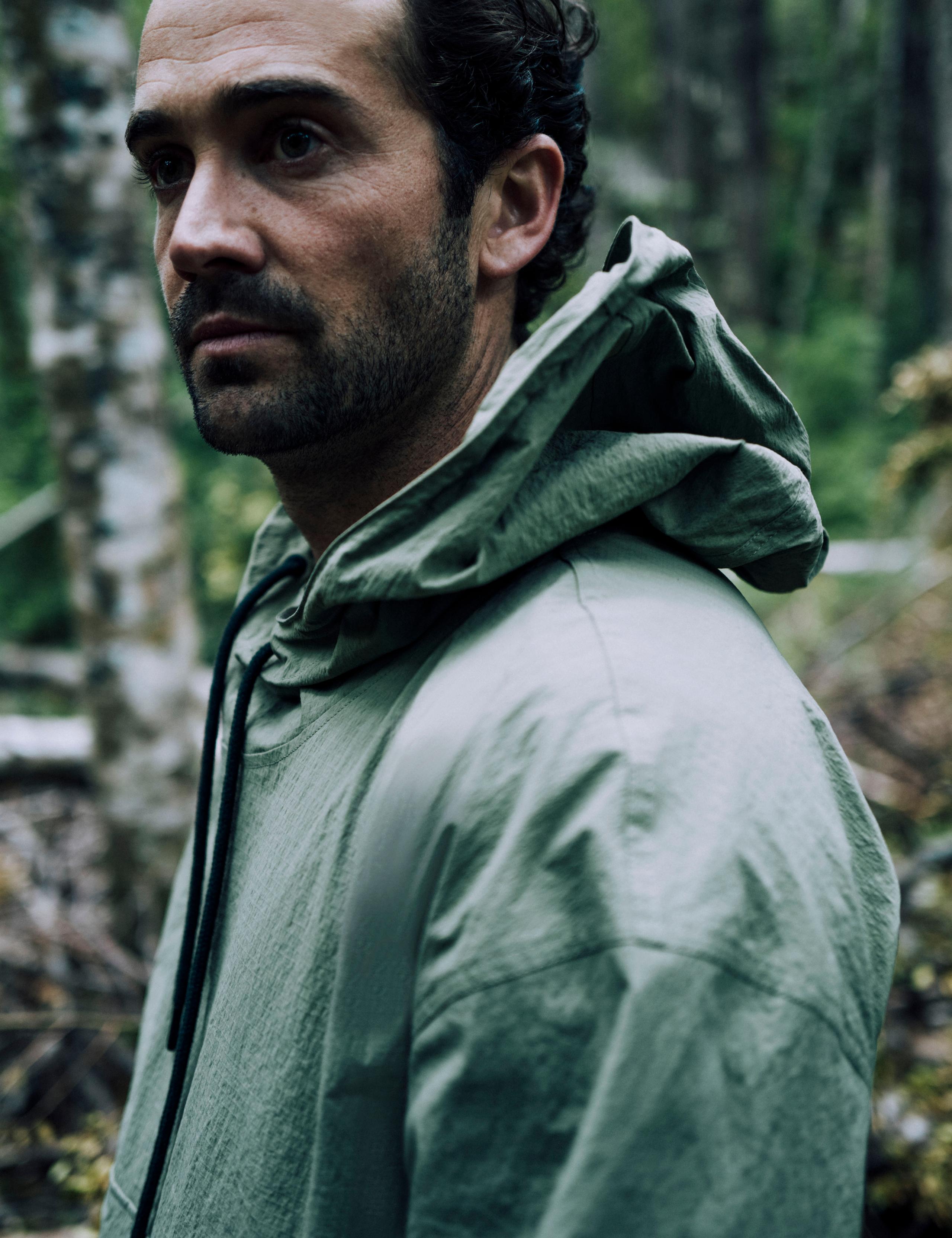 Closeup of man in forest wearing the Harrier Anorak