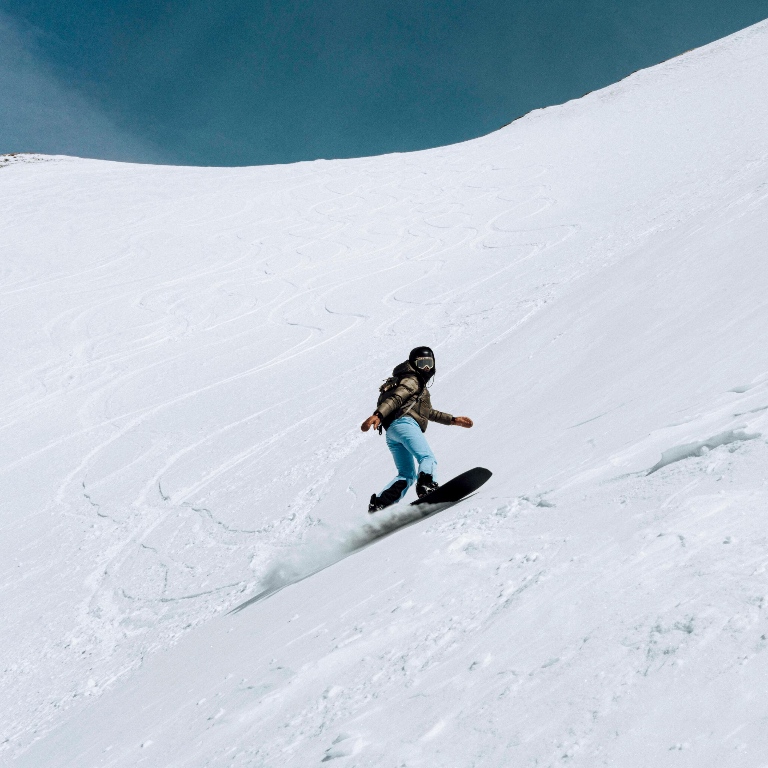 Woman snowboarding on Silverton Mountain, Colorado