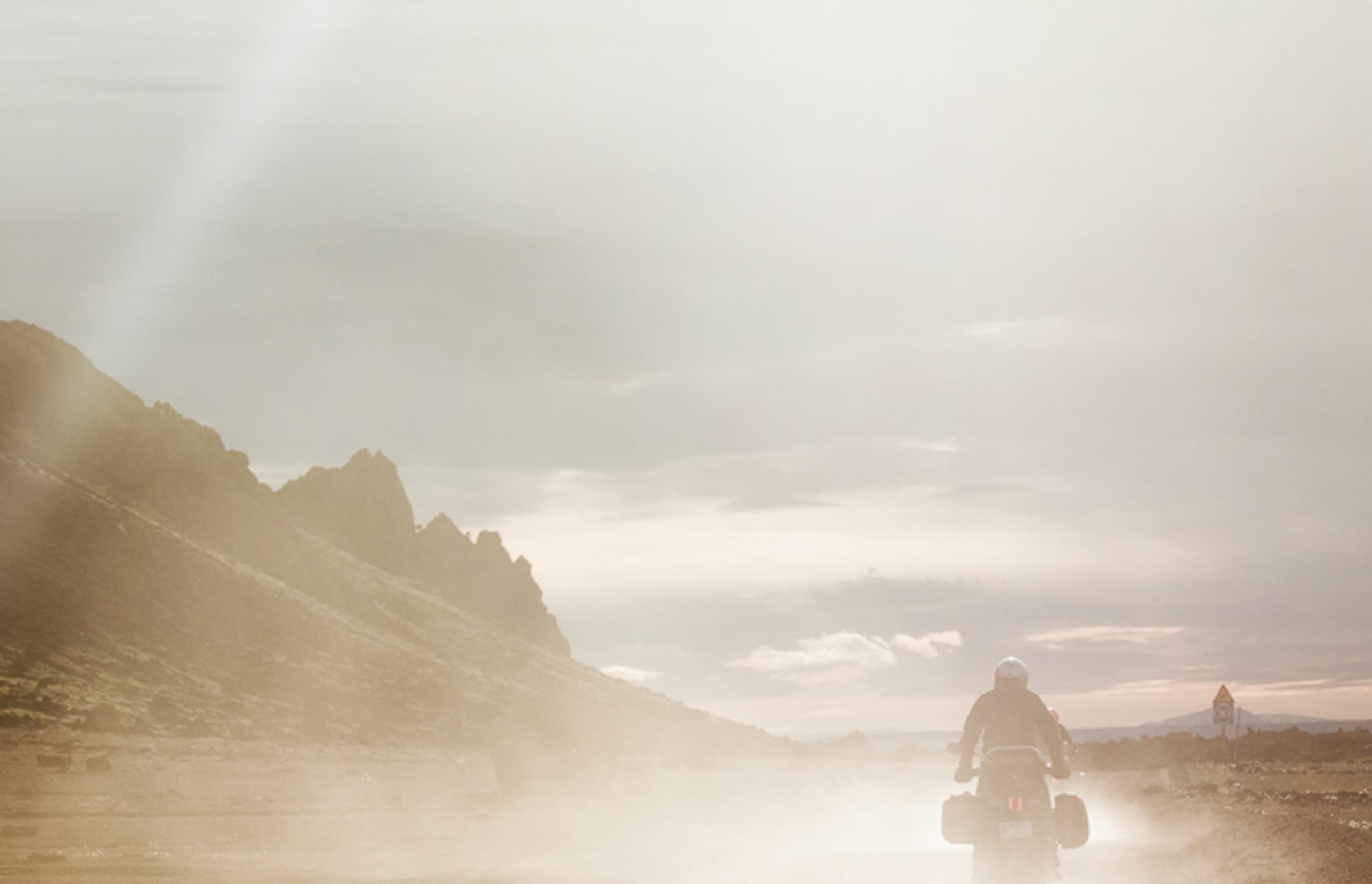 man riding motorcycle through the mountains