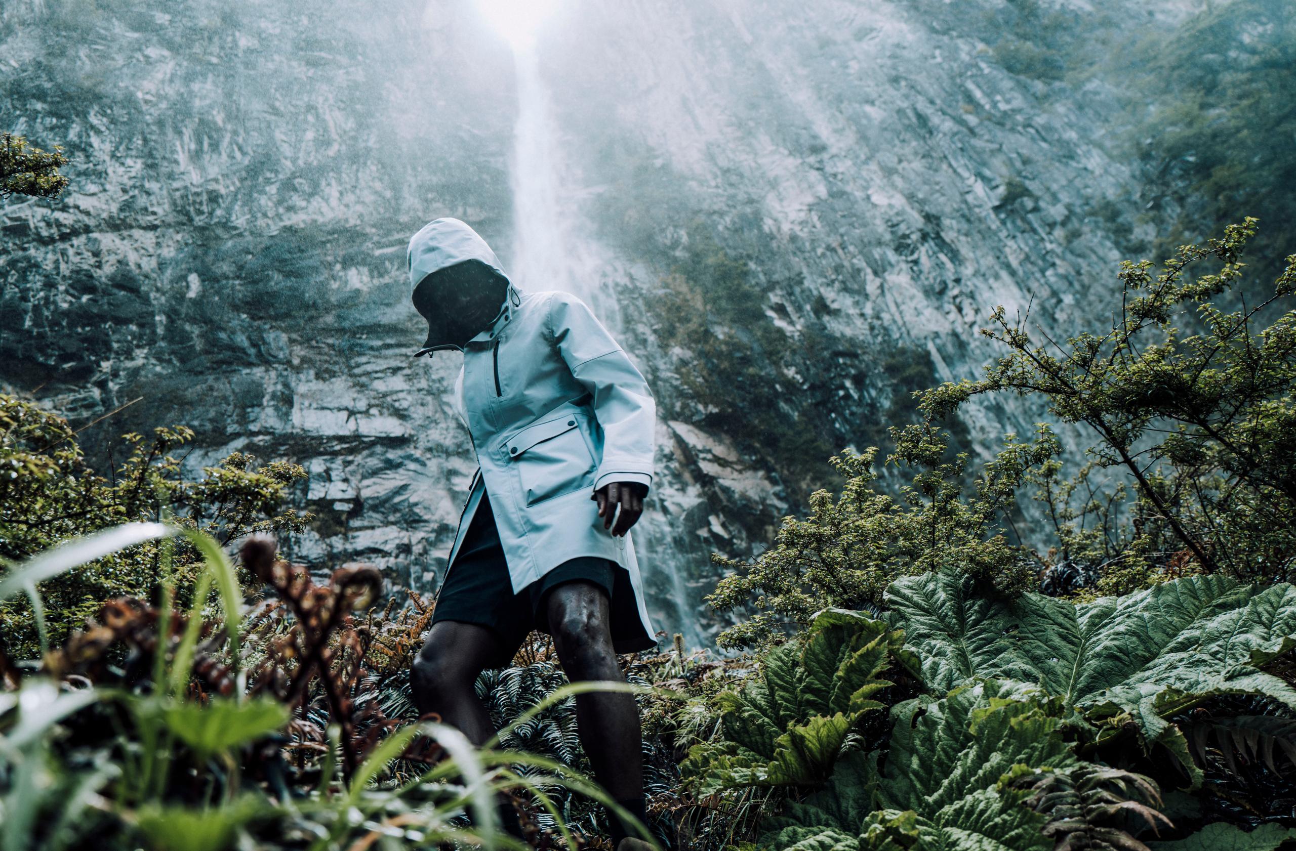Man in Line Rain Poncho in rain from nearby waterfall in Patagonia