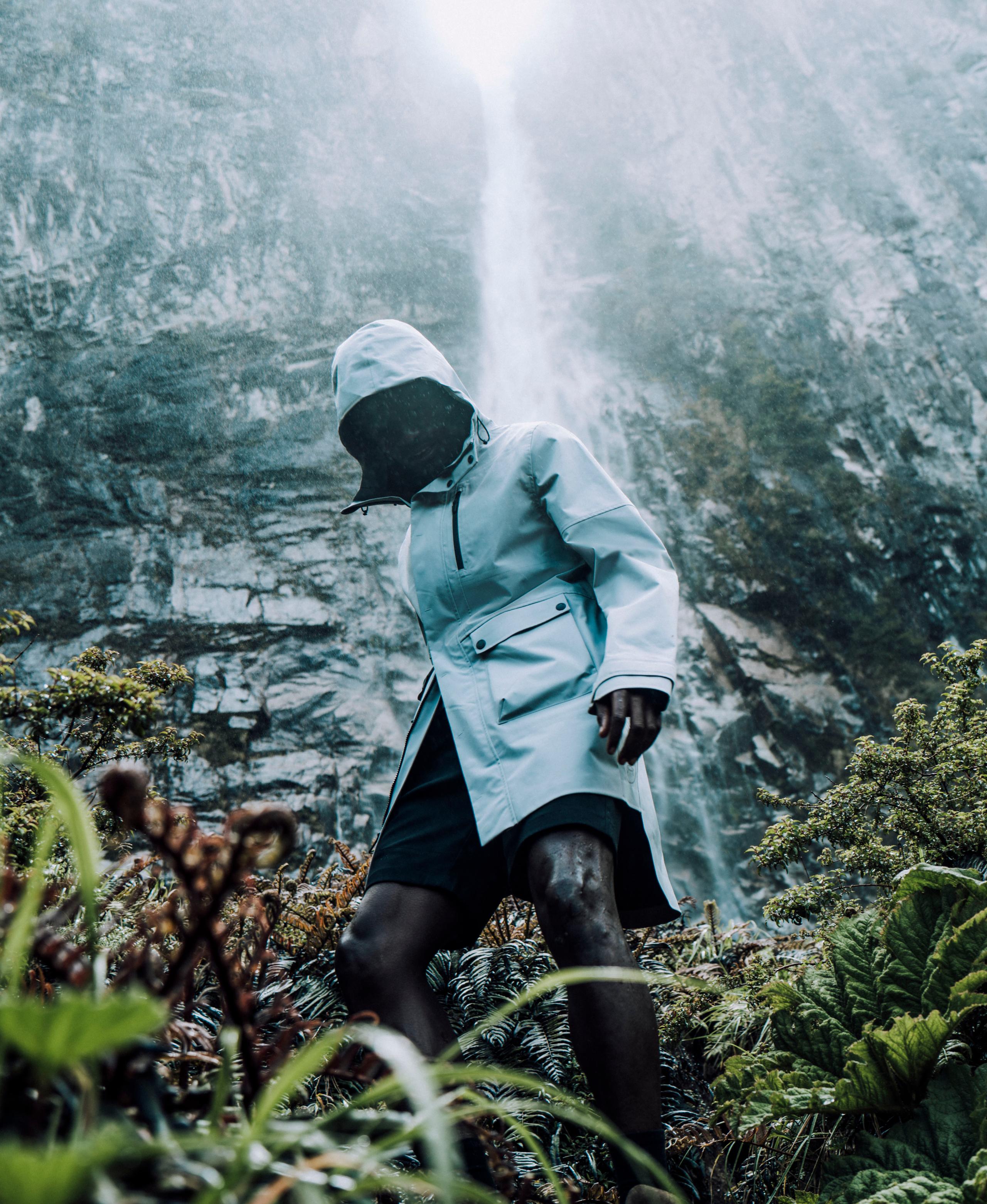 Man in Line Rain Poncho in rain from nearby waterfall in Patagonia