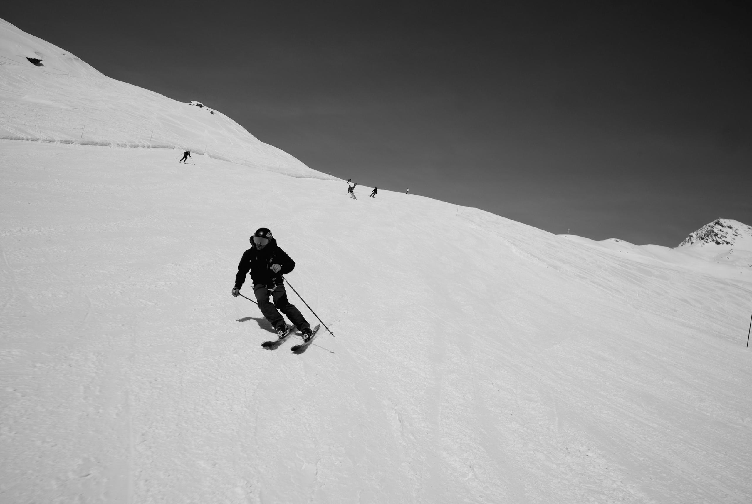 Man skiing down slope in French Alps