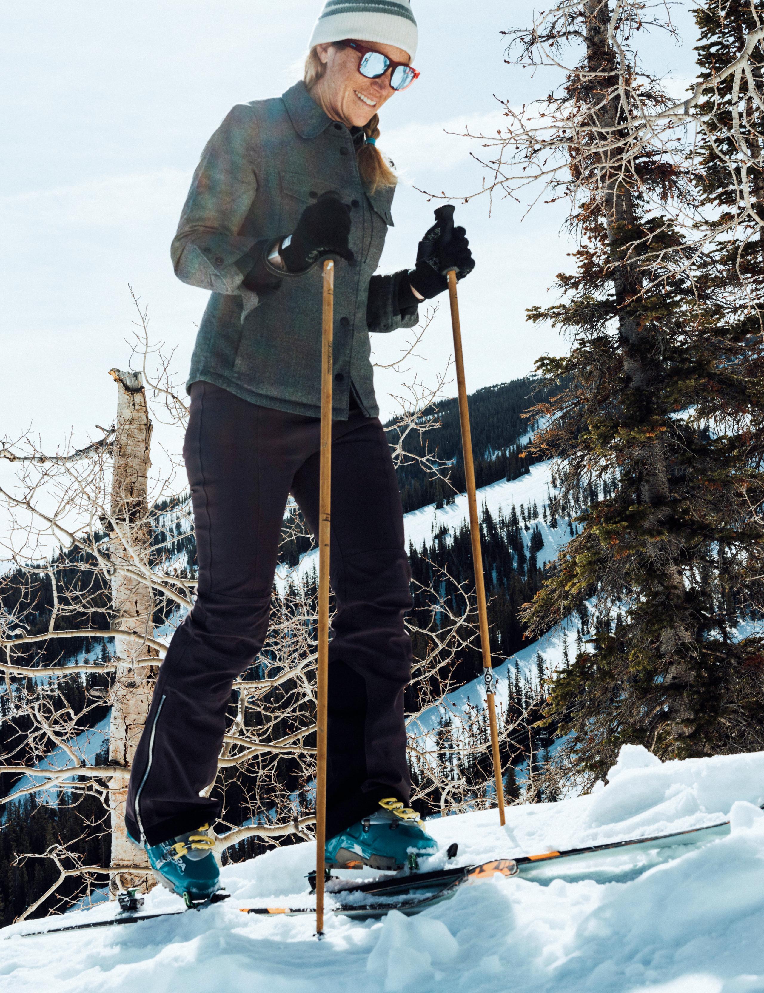 Women in W Traction Insulated Shirt skinning up snow mountain