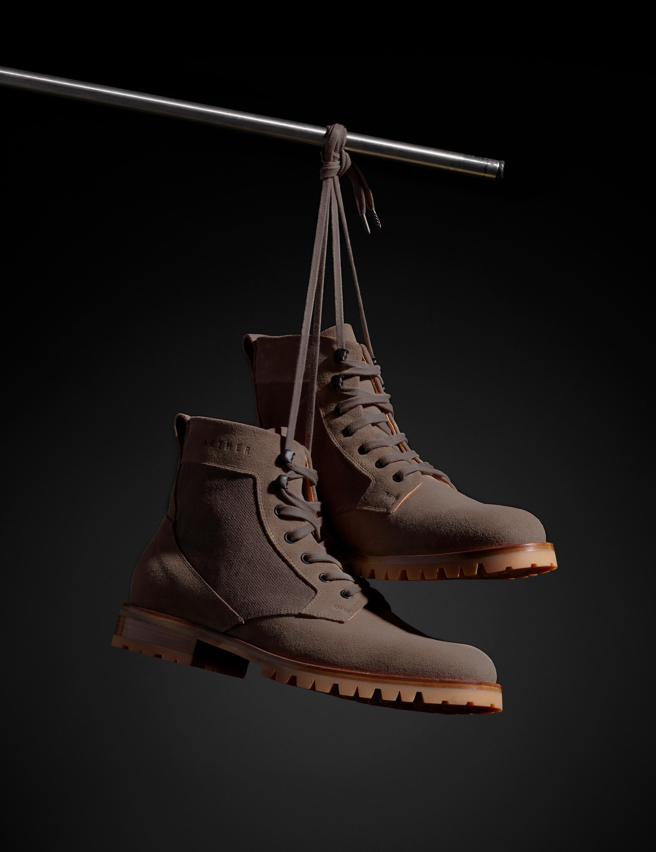 Ojat City Boot hanging by laces from metal rod