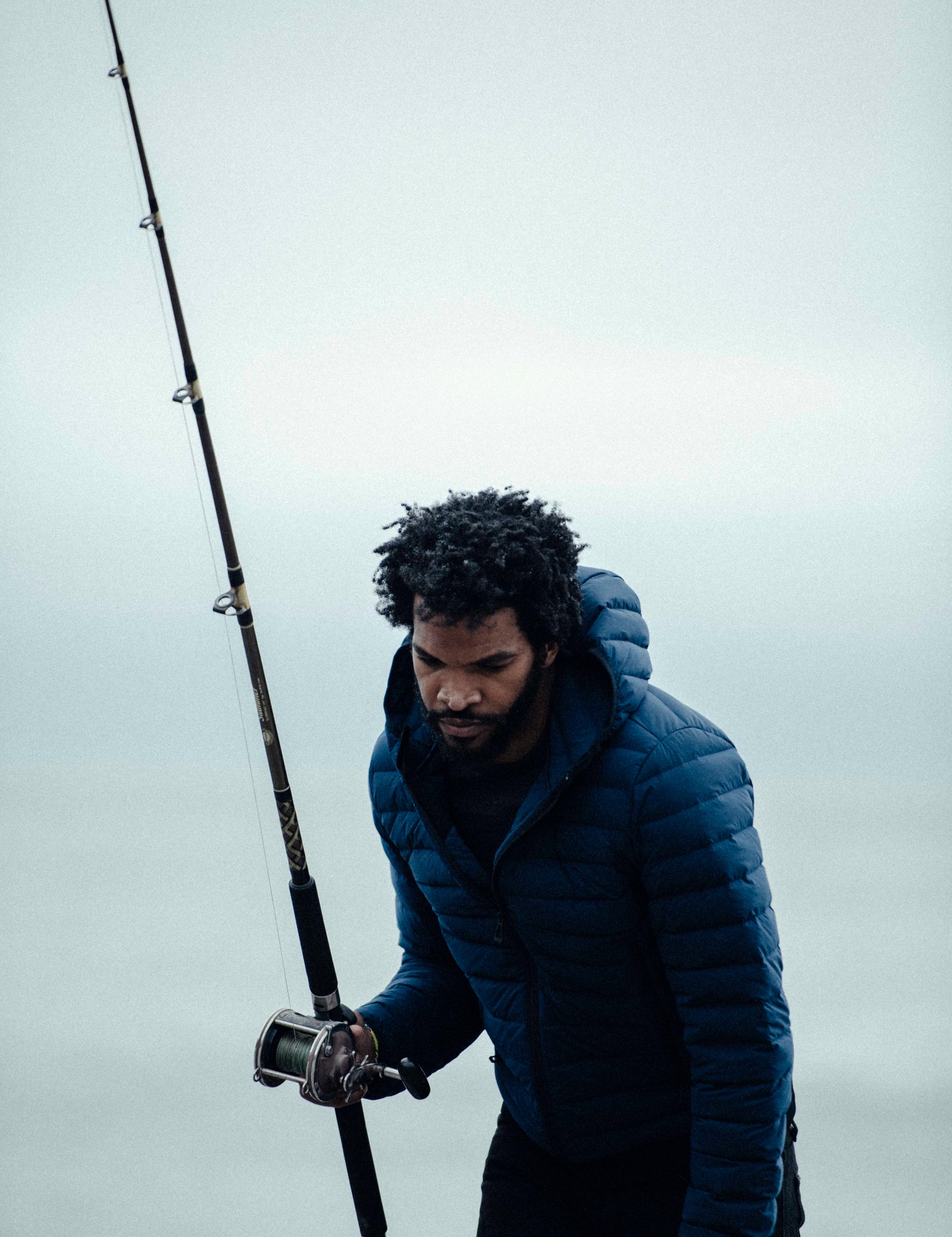 Men in Launch Jacket holding a fishing rod