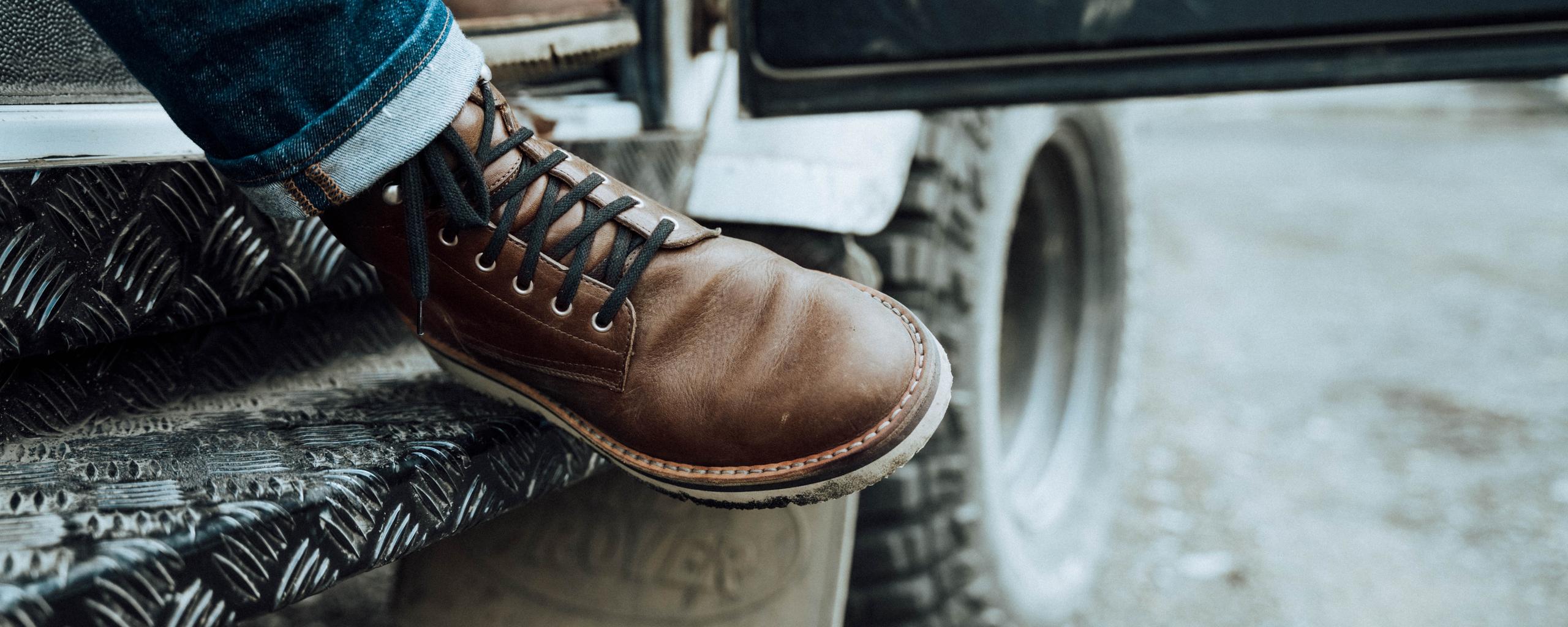 Closeup of man's shoes stepping out of truck