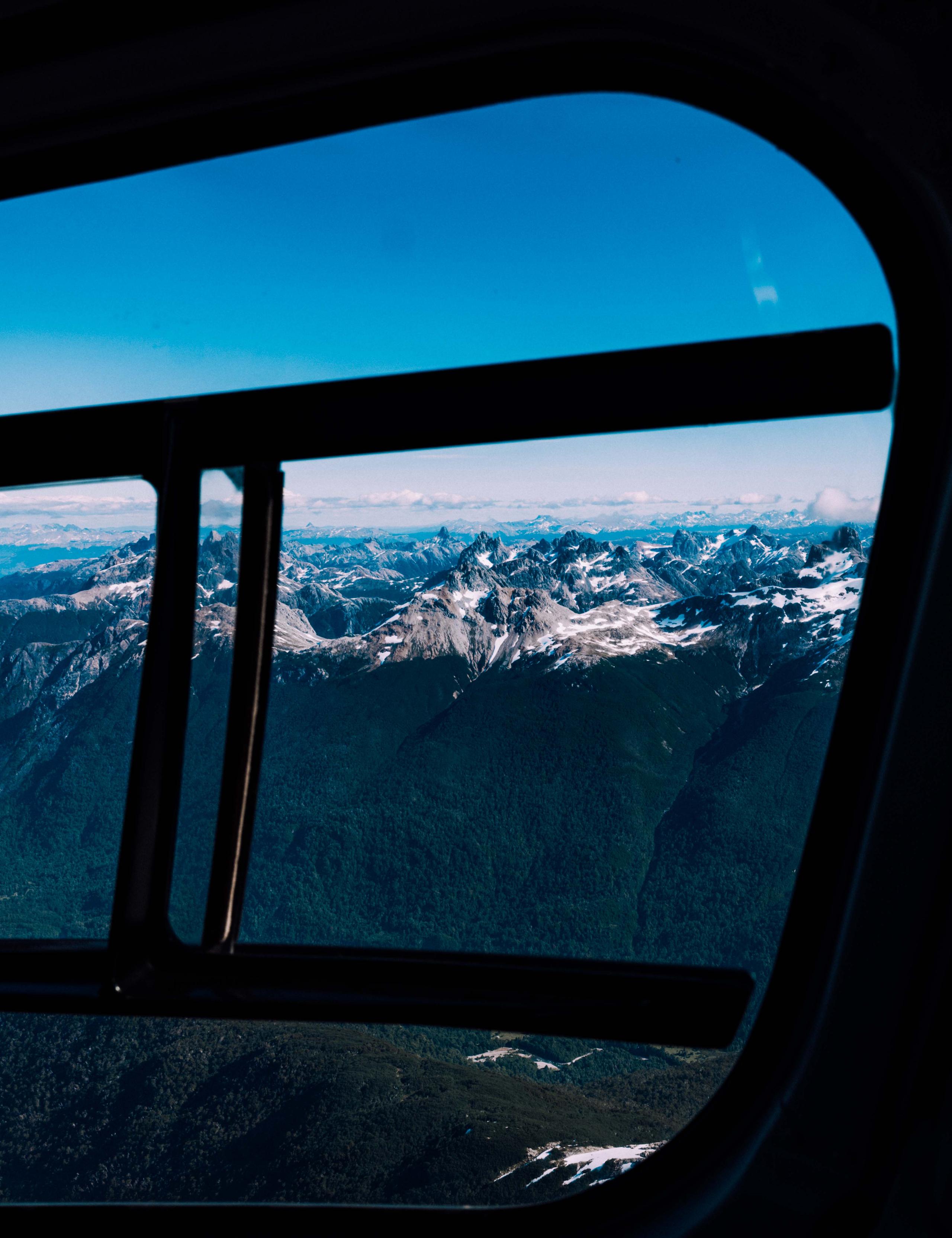 View from inside helicopter overlooking mountains in Patagonia