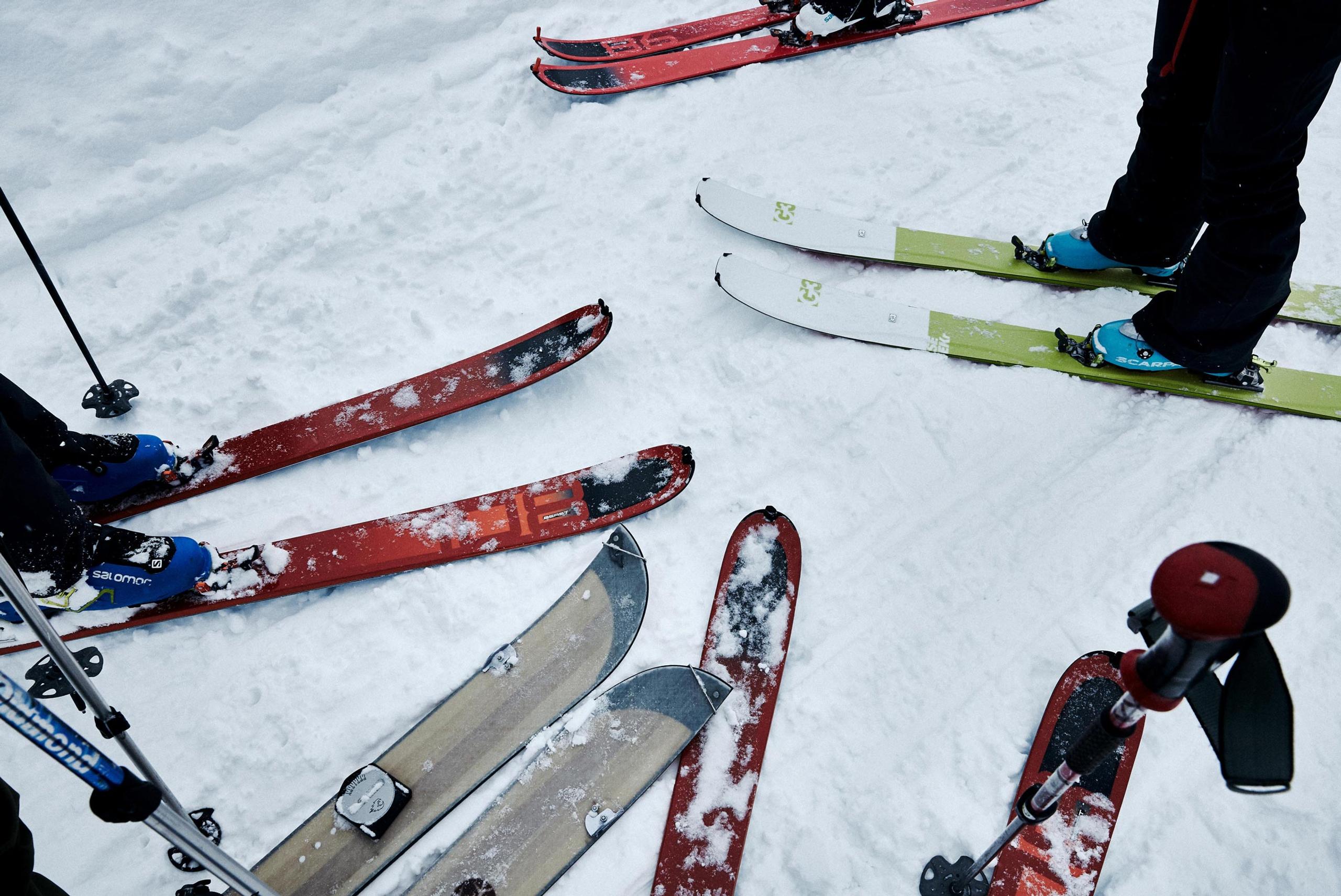 people standing on snowboards in snow