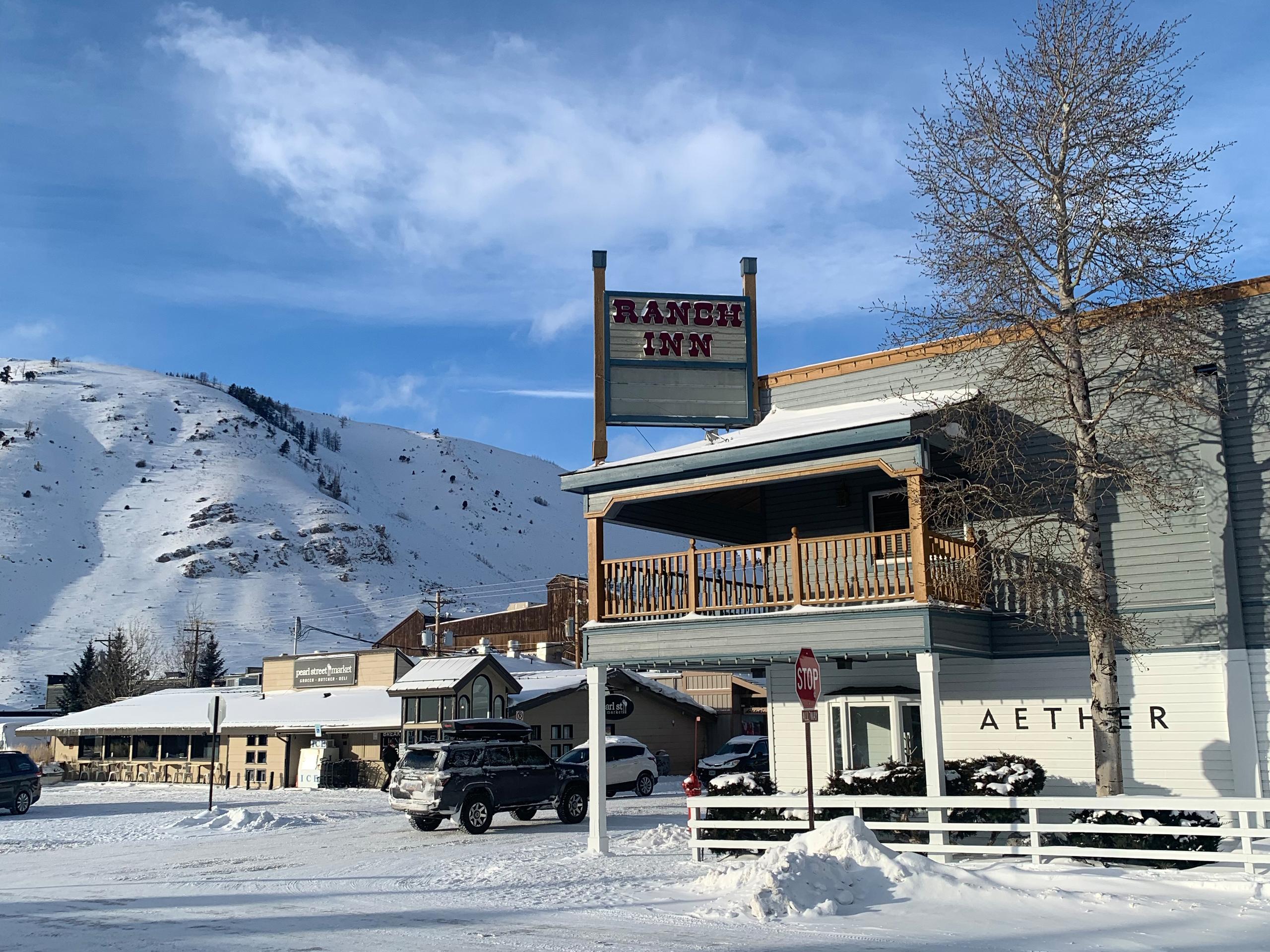 Exterior of AETHER Jackson Hole store with snowy mountain in the background