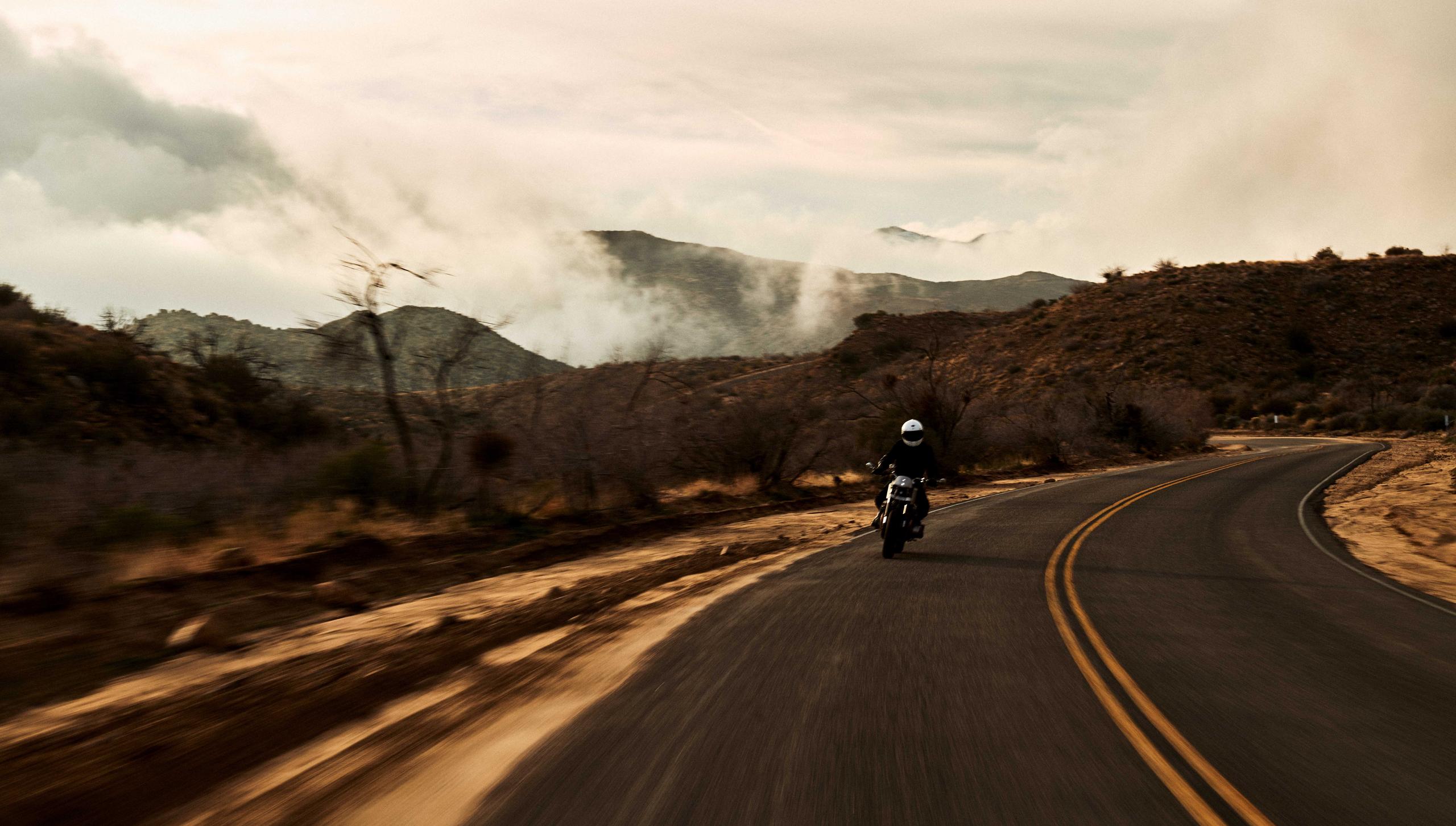 Motorcyclist riding down road in Joshua Tree, California