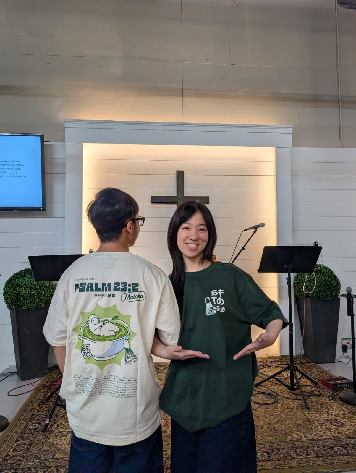 A couple wearing matching GFTD Psalm 23:2 Matcha tees