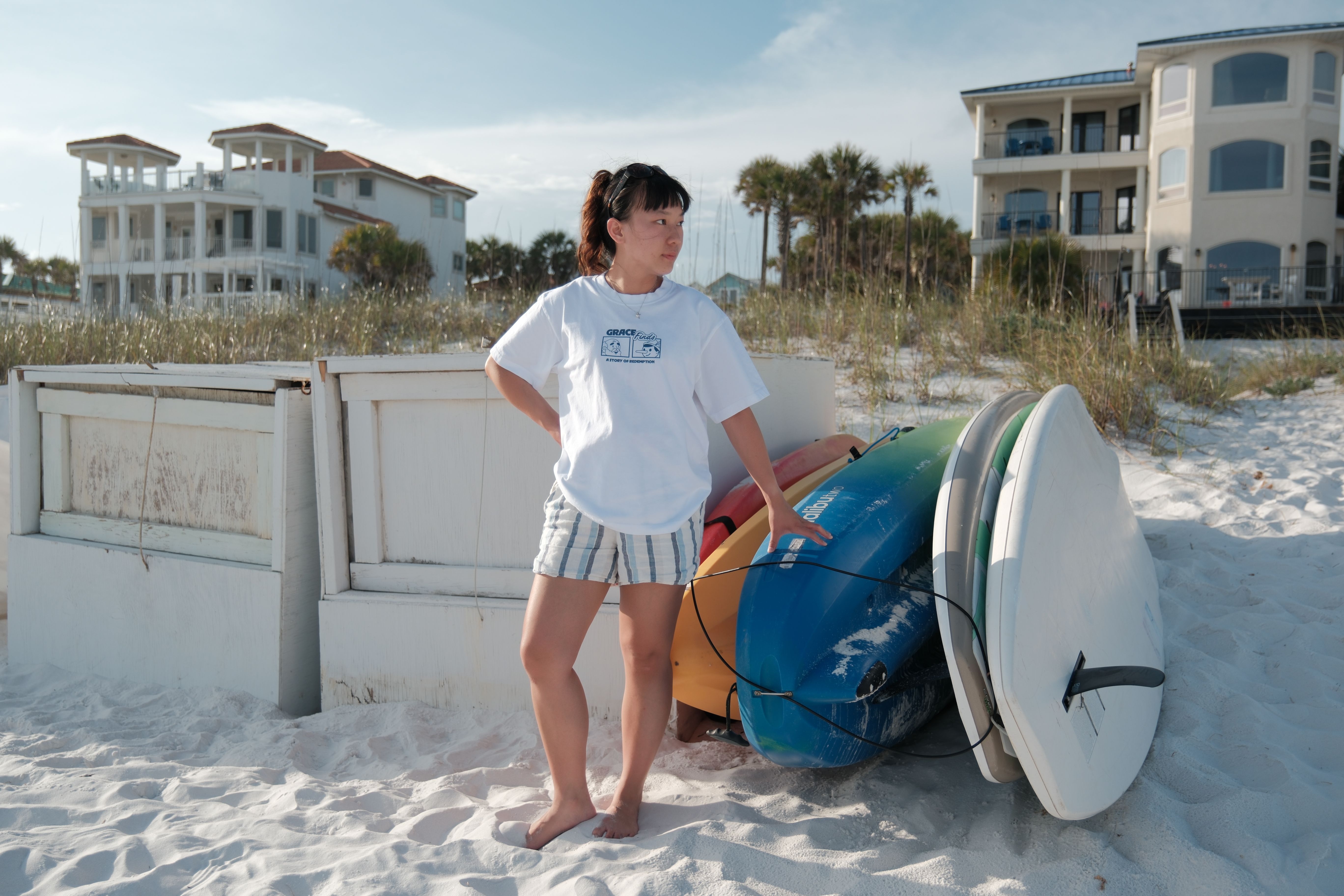A girl on a beach wearing GFTD Jonah tee in white