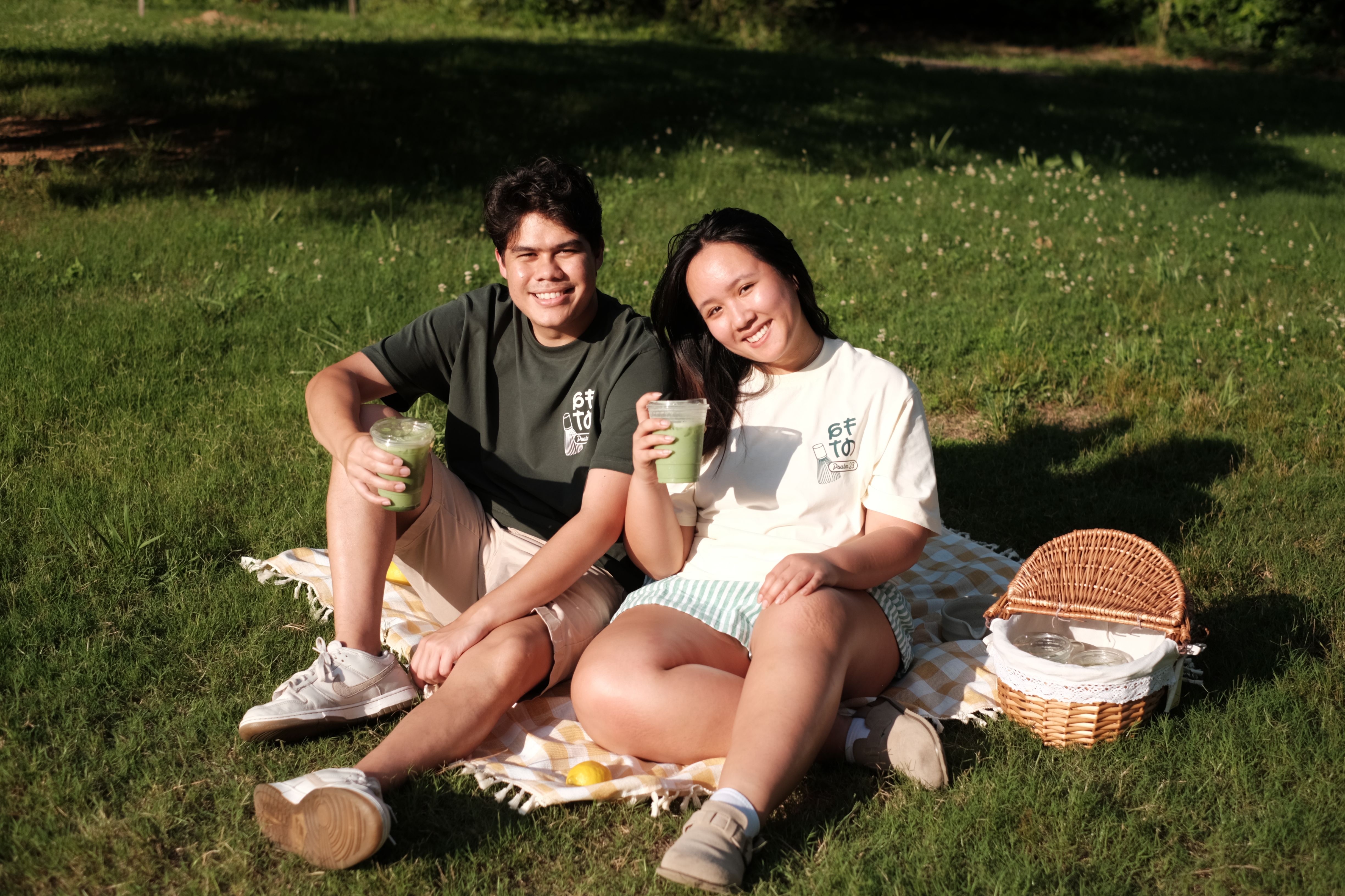A couple wearing matching GFTD Psalm 23:2 Matcha tees