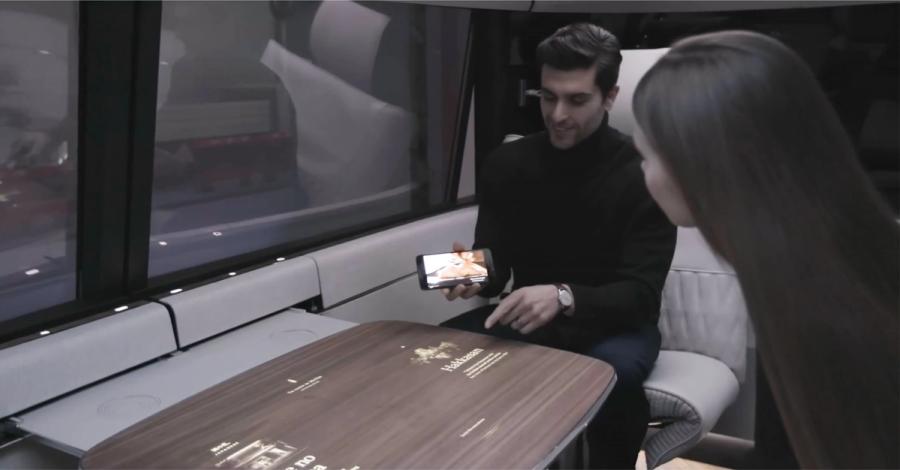 Two passengers at the table inside Ford’s autonomous vehicle simulator