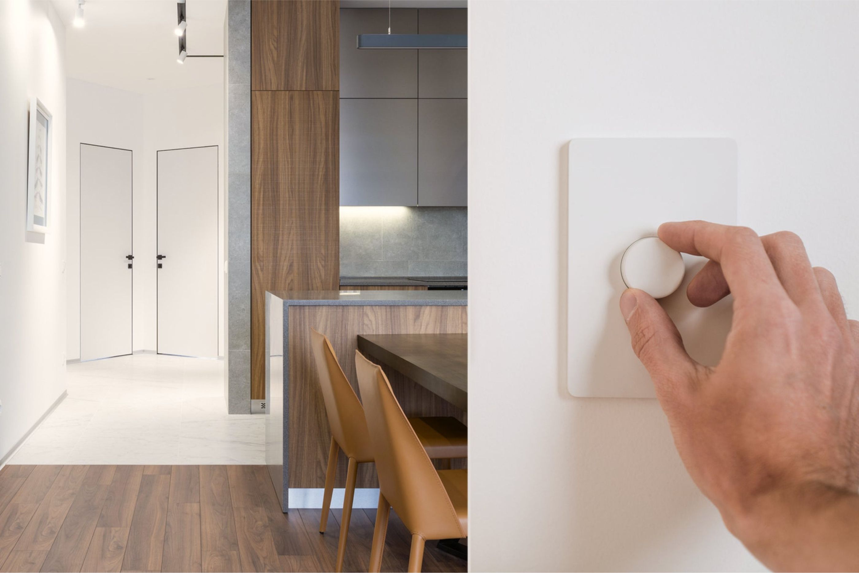 A hand turning a Nokia smart dimmer on a wall