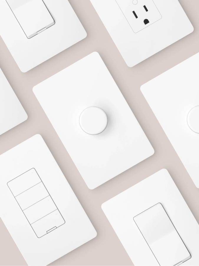 Nokia smart switches, dimmers and sockets laid out on a pale table