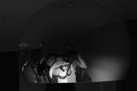 A self portrait of me and my family reflected in a spherical lampshade.