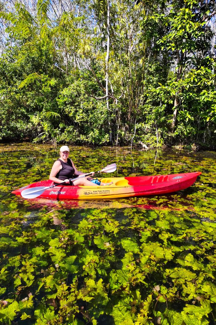 woman kayaking in klong root in krabi, thailand