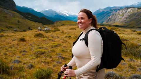 woman smiling as she hikes in el chalten, argentina