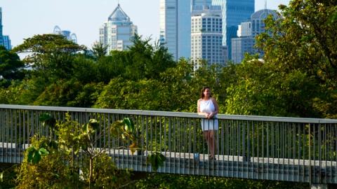 woman walking on the trails in lumpini park in Bangkok, Thailand
