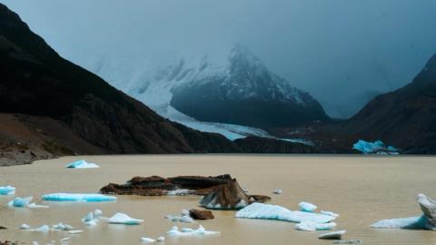 clouds covering the mounbtains behind Laguna Torre in el chalten, argentina