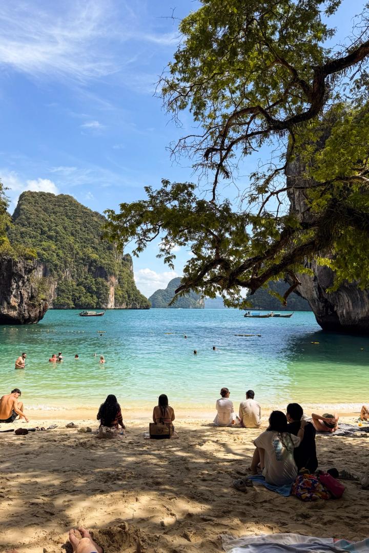 people watching the beach in krabi, thailand