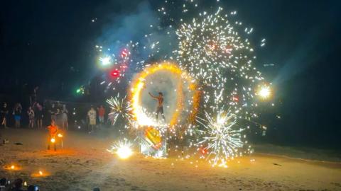 a man doing a fire show in krabi, thailand