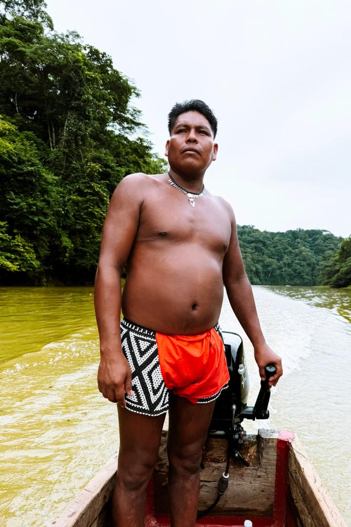 a man from the embera tribe taking us to his village in a kayak outside panama city