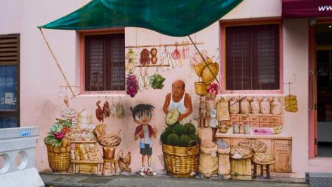 Pink mural of an old man and a cartoon selling fruit in chinatown, Singapore