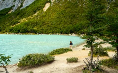 woman hiking to esmeralda lagoon in ushuaia, argentina