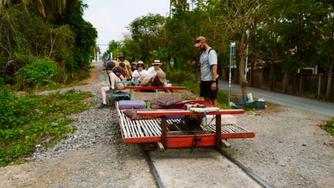 A group of people waiting to take the bamboo train in Battambang, Cambodia