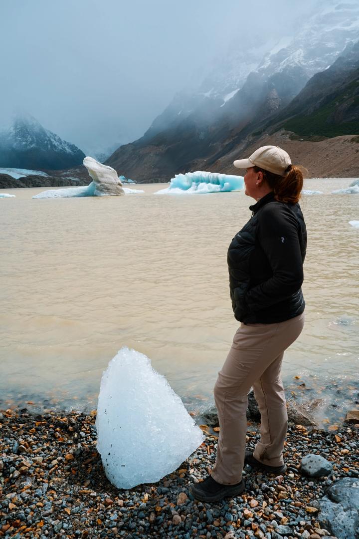 woman standing in front of Laguna Torre in el chalten, argentina