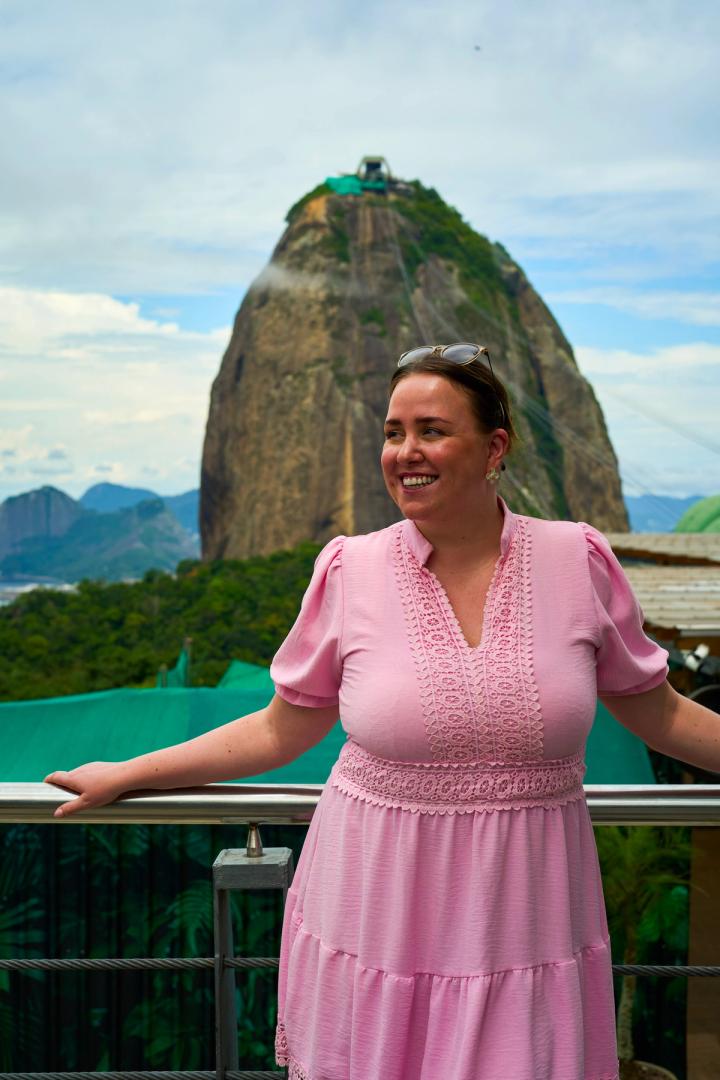 woman standing in front of sugarloaf mountain in rio de janeiro, brazil