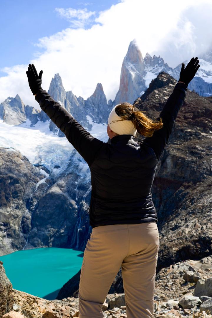 woman standing in front of laguna sucia in el chalten, argentina