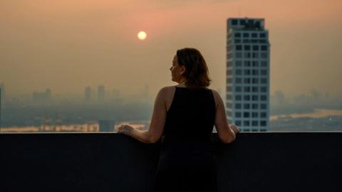 woman watching the sunset in Bangkok, Thailand