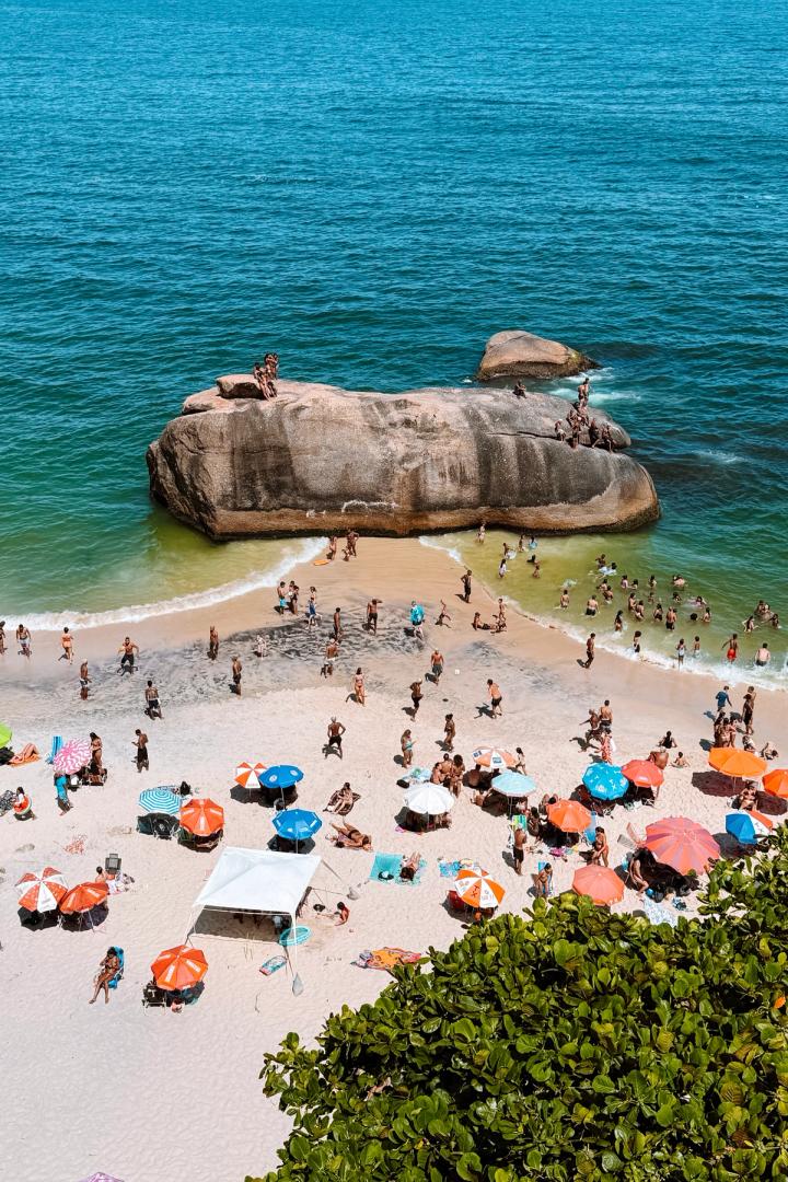a beach with people swimming in Rio de Janeiro, brazil