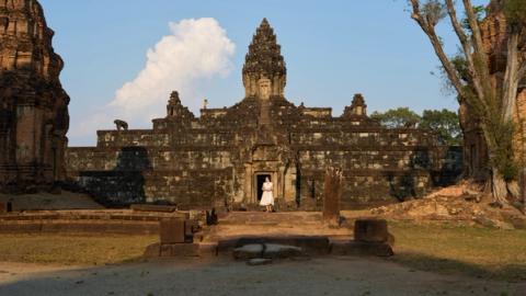 woman in white dress in front of a temple in siem reap, cambodia