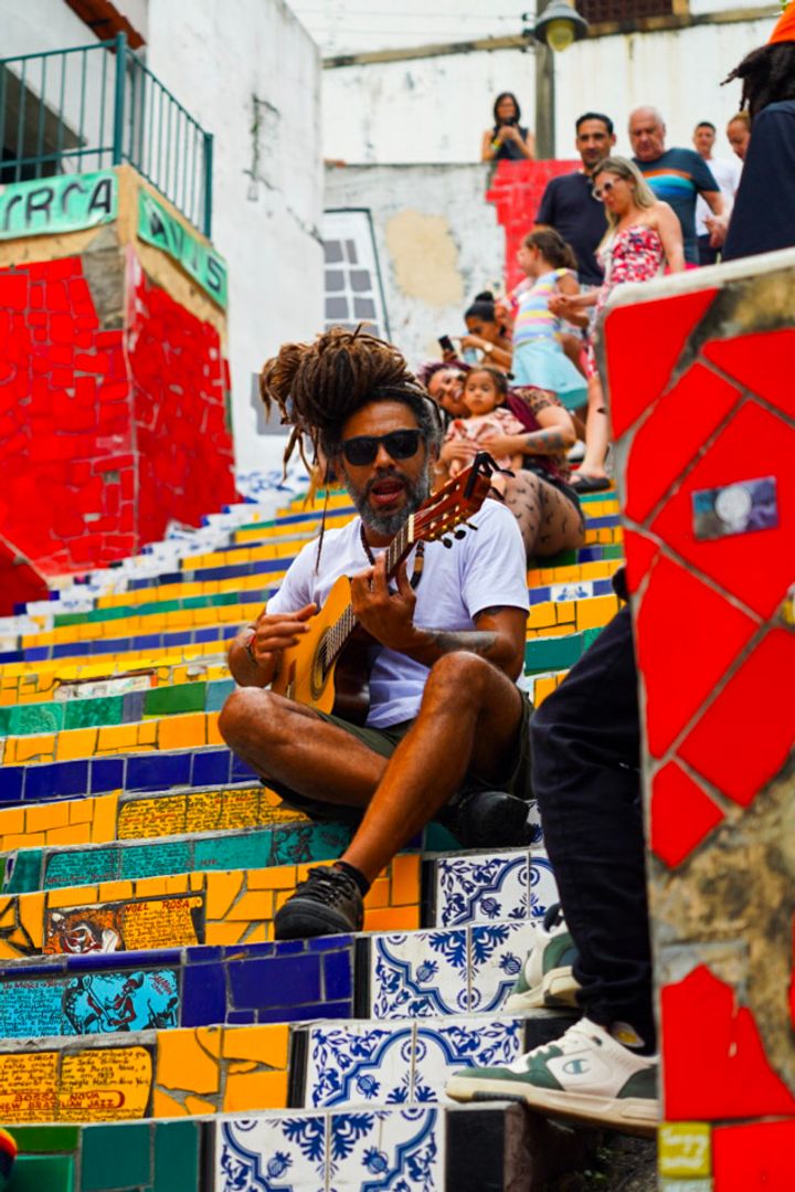 man playing music in the Selaron steps in rio de janeiro, brazil