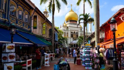Arab street in Singapore with view of the mosque and people walking around