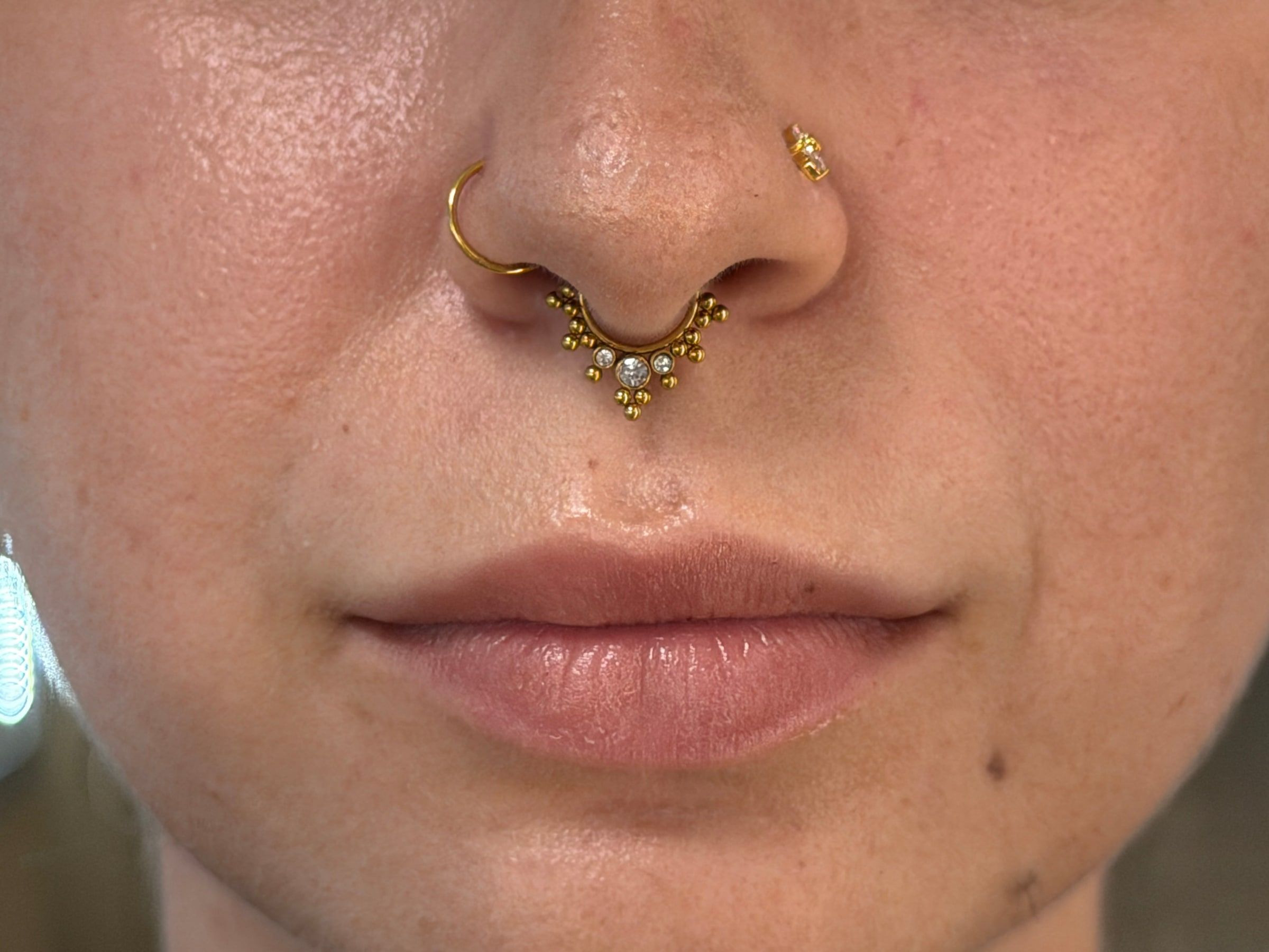 Septum a nostril piercing