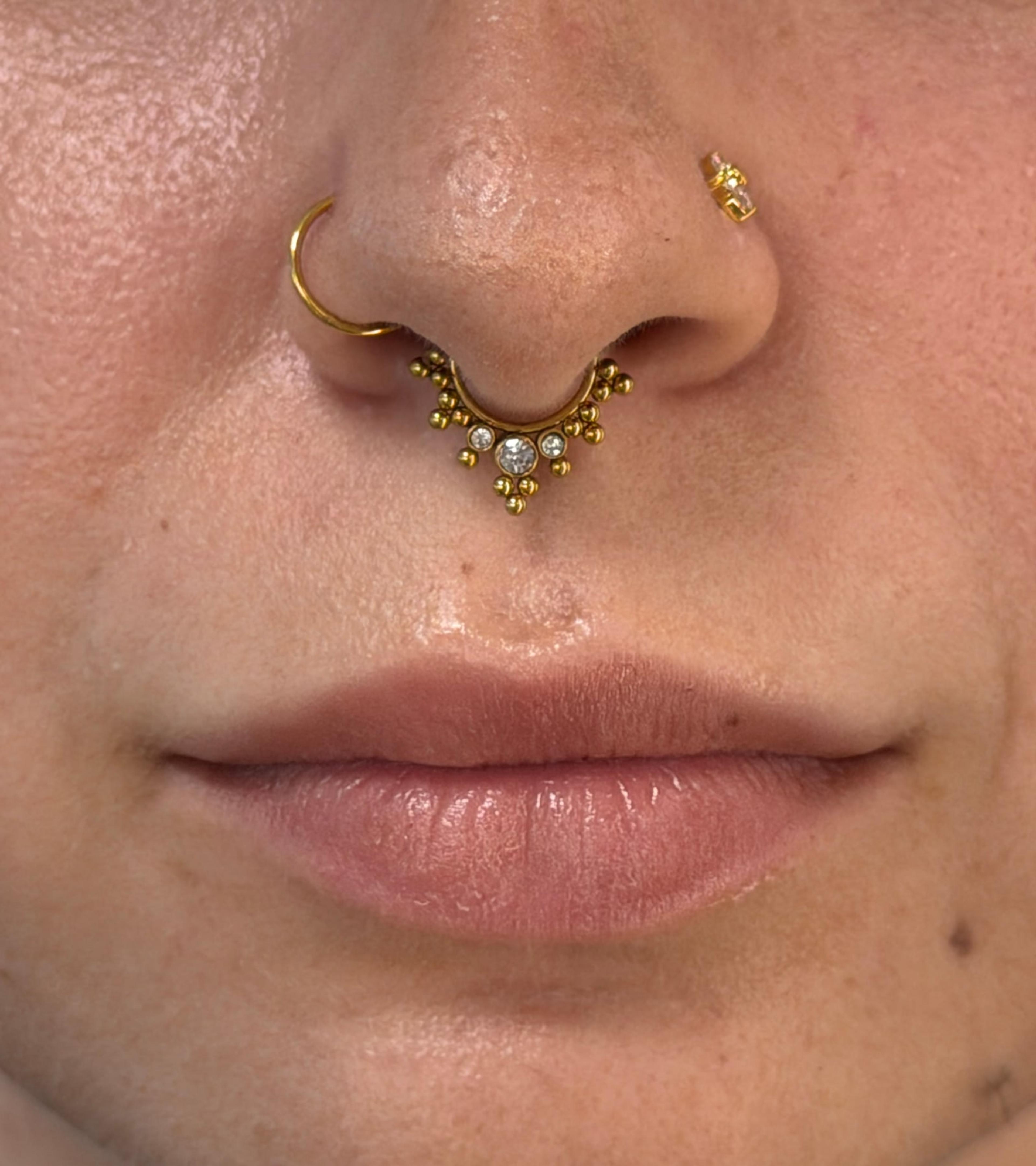 Septum a nostril piercing