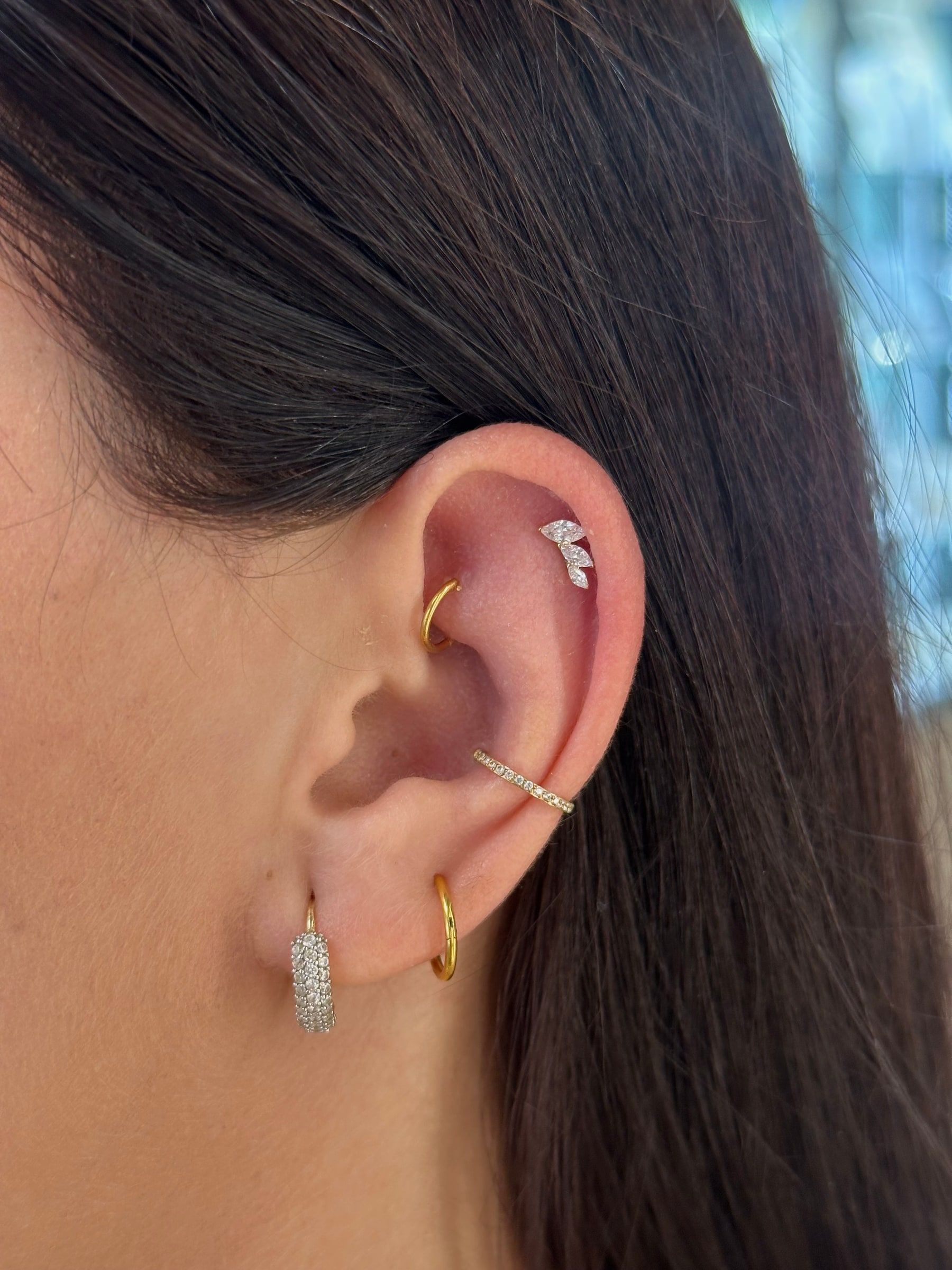 Ucho s piercingami helix, daith, conch a lalok