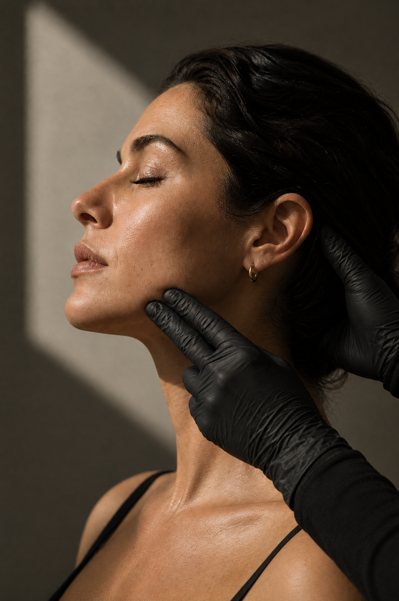 Physician assessing the jawline before an HArmonyCa treatment